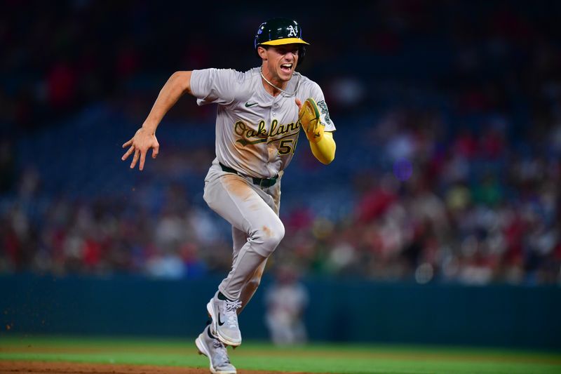 Jun 25, 2024; Anaheim, California, USA; Oakland Athletics third baseman Armando Alvarez (50) runs to third on a pickoff error by Los Angeles Angels pitcher Ben Joyce (44) during the eighth inning at Angel Stadium. Mandatory Credit: Gary A. Vasquez-USA TODAY Sports