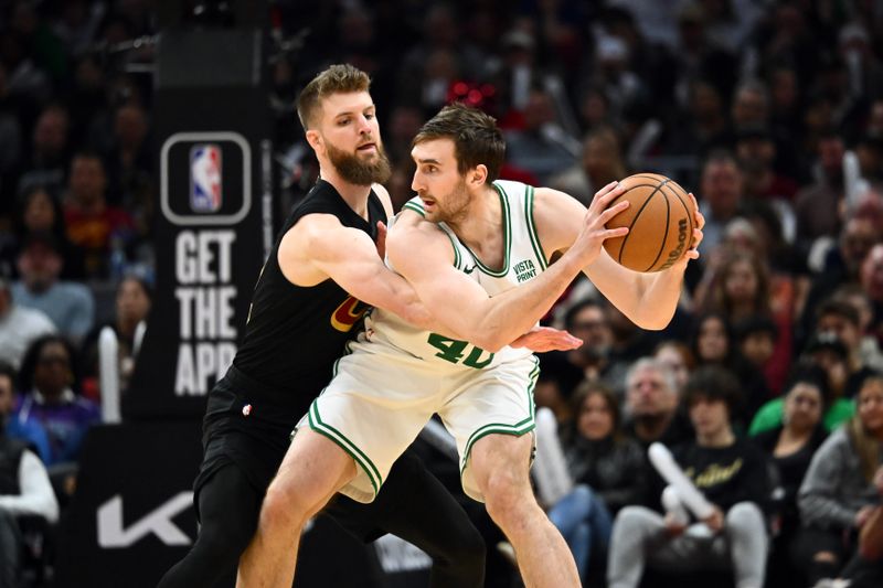 CLEVELAND, OHIO - MARCH 05: Dean Wade #32 of the Cleveland Cavaliers guards Luke Kornet #40 of the Boston Celtics during the fourth quarter at Rocket Mortgage Fieldhouse on March 05, 2024 in Cleveland, Ohio. The Cavaliers defeated the Celtics 105-104. NOTE TO USER: User expressly acknowledges and agrees that, by downloading and or using this photograph, User is consenting to the terms and conditions of the Getty Images License Agreement. (Photo by Jason Miller/Getty Images)