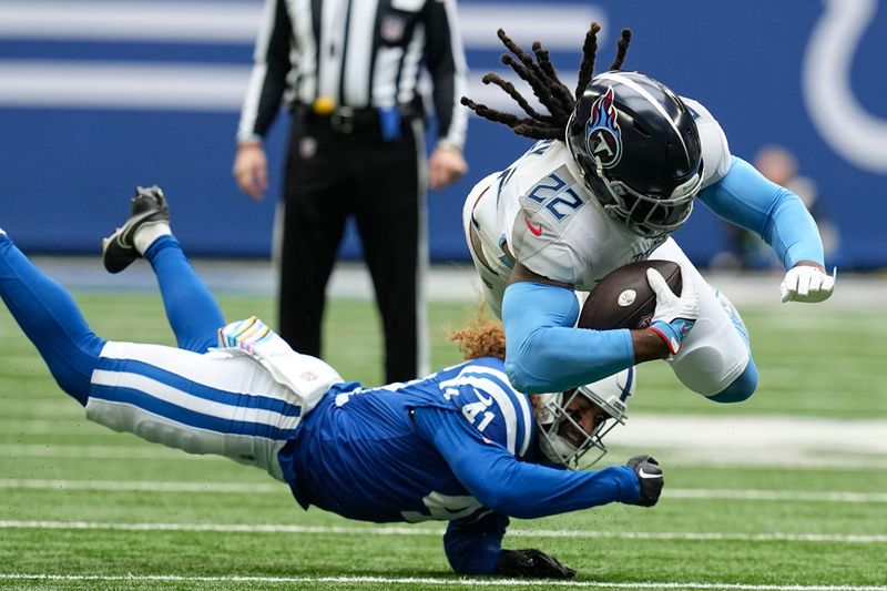 Tennessee Titans running back Derrick Henry (22) dives for extra yards past past Indianapolis Colts linebacker Grant Stuard, left, during the first half of an NFL football game, Sunday, Oct. 8, 2023, in Indianapolis. (AP Photo/Darron Cummings)