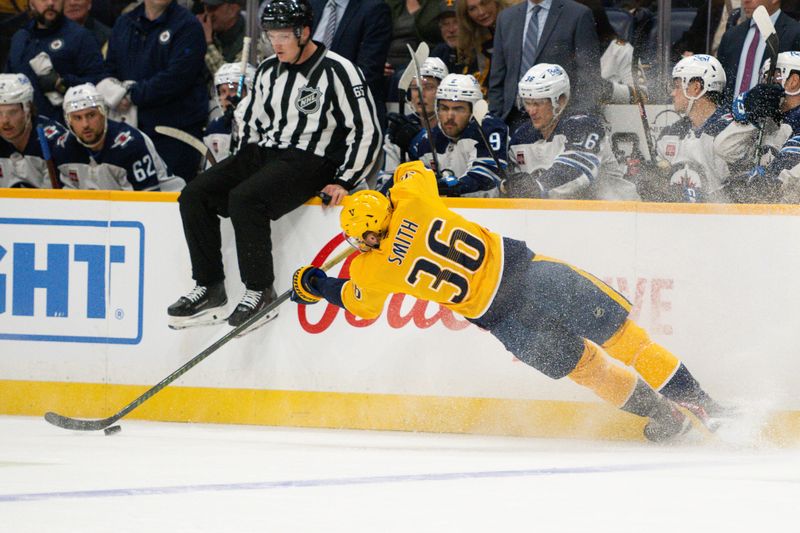 Nov 23, 2024; Nashville, Tennessee, USA;  Nashville Predators left wing Cole Smith (36) dives for the puck against the Winnipeg Jets during the first period at Bridgestone Arena. Mandatory Credit: Steve Roberts-Imagn Images