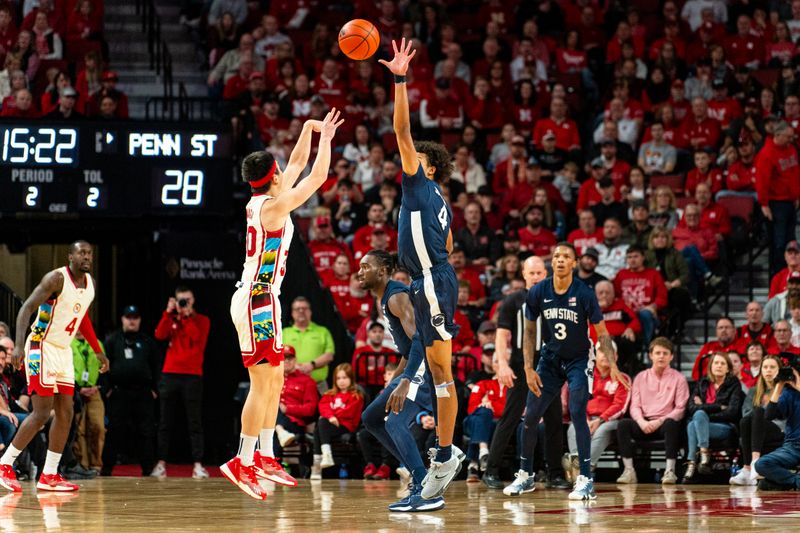 Feb 17, 2024; Lincoln, Nebraska, USA; Nebraska Cornhuskers guard Keisei Tominaga (30) shoots a 3-point shot against Penn State Nittany Lions forward Puff Johnson (4) during the second half at Pinnacle Bank Arena. Mandatory Credit: Dylan Widger-USA TODAY Sports