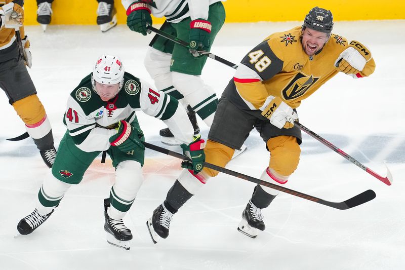 Apr 20, 2025; Las Vegas, Nevada, USA; Vegas Golden Knights center Tomas Hertl (48) reacts after taking a slash next to Minnesota Wild center Gustav Nyquist (41) during the third period of game one of the first round of the 2025 Stanley Cup Playoffs at T-Mobile Arena. Mandatory Credit: Stephen R. Sylvanie-Imagn Images