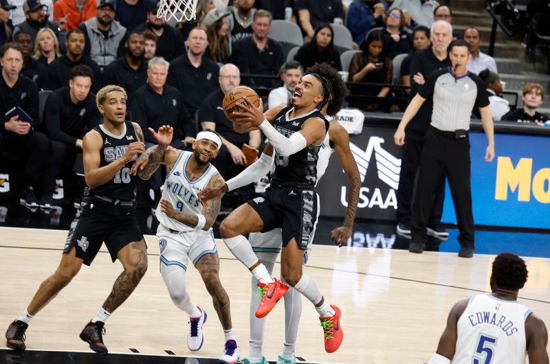 SAN ANTONIO, TX - JANUARY 27:  Tre Jones #33 of the San Antonio Spurs drives on the Minnesota Timberwolves in the first half at Frost Bank Center on January 27, 2024 in San Antonio, Texas. NOTE TO USER: User expressly acknowledges and agrees that, by downloading and or using this photograph, User is consenting to terms and conditions of the Getty Images License Agreement. (Photo by Ronald Cortes/Getty Images)