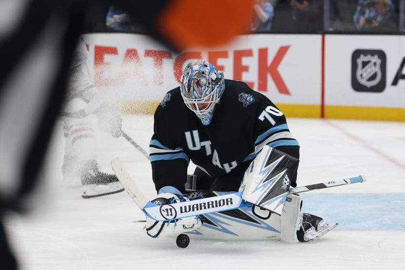 Feb 25, 2025; Salt Lake City, Utah, USA; Utah Hockey Club goaltender Karel Vejmelka (70) covers up the puck during the second period of a game against the Chicago Blackhawks at Delta Center. Mandatory Credit: Rob Gray-Imagn Images