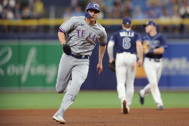 Oct 4, 2023; St. Petersburg, Florida, USA; Texas Rangers shortstop Corey Seager (5) runs to third base against the Tampa Bay Rays in the fifth inning during game two of the Wildcard series for the 2023 MLB playoffs at Tropicana Field. Mandatory Credit: Nathan Ray Seebeck-USA TODAY Sports