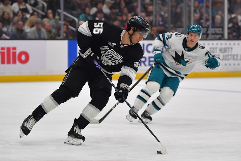 Jan 7, 2026; Los Angeles, California, USA; Los Angeles Kings right wing Quinton Byfield (55) moves the puck ahead of San Jose Sharks left wing William Eklund (72) during the first period at Crypto.com Arena. Mandatory Credit: Gary A. Vasquez-Imagn Images