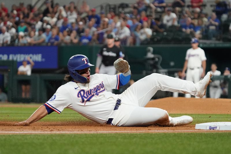 Sep 20, 2025; Arlington, Texas, USA; Texas Rangers outfielder Alejandro Osuna (19) slides into third base during the third inning against the Miami Marlins at Globe Life Field. Mandatory Credit: Raymond Carlin III-Imagn Images