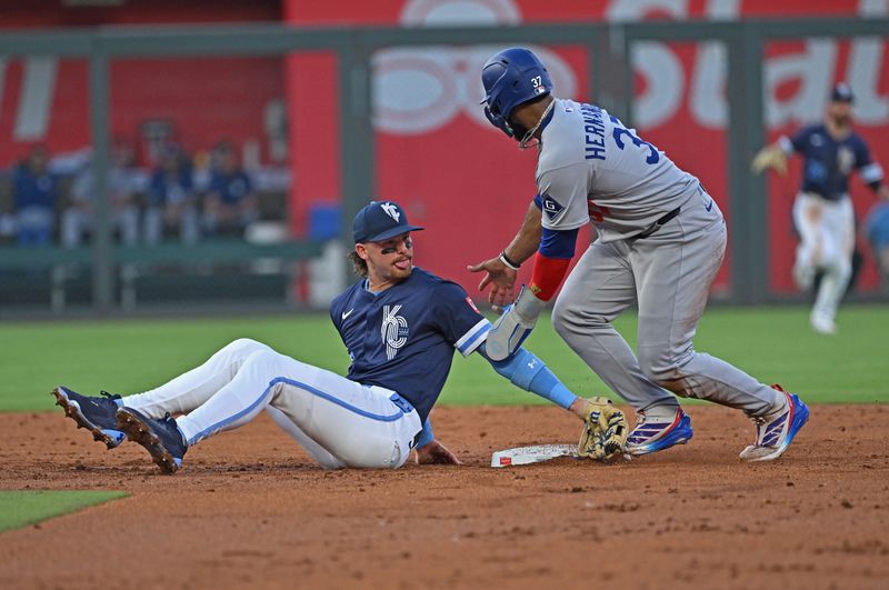 Jun 27, 2025; Kansas City, Missouri, USA;  Los Angeles Dodgers right fielder Teoscar Hernandez (37) gets up to run to third base, as Kansas City Royals shortstop Bobby Witt Jr. (7) looks back in the third inning at Kauffman Stadium. Mandatory Credit: Peter Aiken-Imagn Images