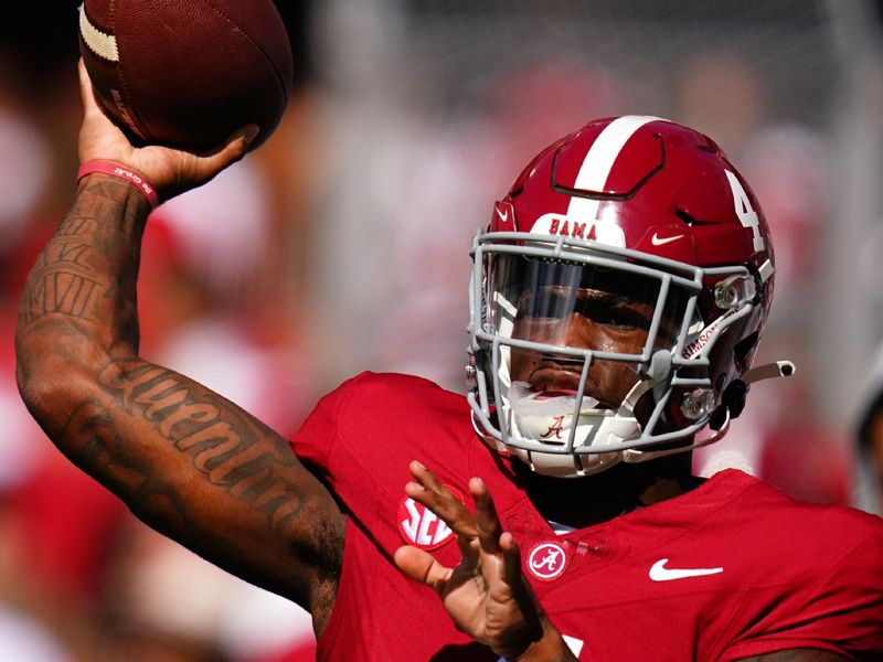 Oct 14, 2023; Tuscaloosa, Alabama, USA; Alabama Crimson Tide quarterback Jalen Milroe (4) passing during warmups prior to their game against the Arkansas Razorbacks at Bryant-Denny Stadium. Mandatory Credit: John David Mercer-USA TODAY Sports