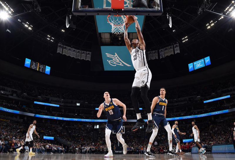 DENVER, CO - MARCH 12: Nicolas Claxton #33 of the Brooklyn Nets drives to the basket during the game against the Denver Nuggets on March 12, 2023 at the Ball Arena in Denver, Colorado. NOTE TO USER: User expressly acknowledges and agrees that, by downloading and/or using this Photograph, user is consenting to the terms and conditions of the Getty Images License Agreement. Mandatory Copyright Notice: Copyright 2023 NBAE (Photo by Garrett Ellwood/NBAE via Getty Images)