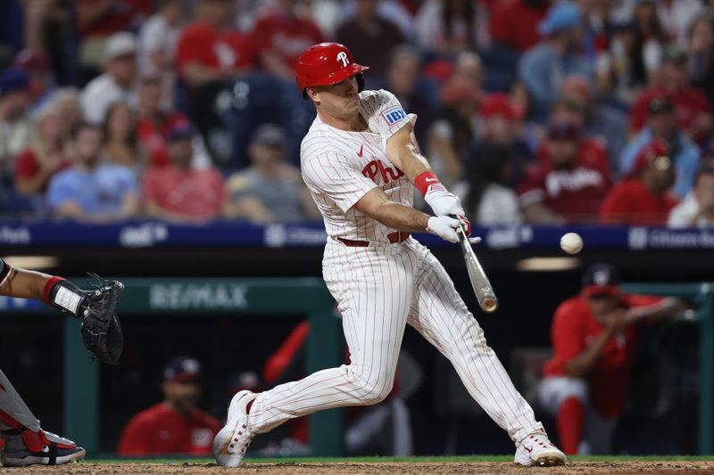 Apr 30, 2025; Philadelphia, Pennsylvania, USA; Philadelphia Phillies catcher J.T. Realmuto (10) hits a home run during the eighth inning against the Washington Nationals at Citizens Bank Park. Mandatory Credit: Bill Streicher-Imagn Images