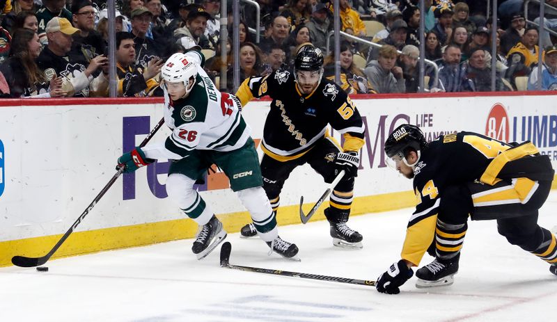 Apr 6, 2023; Pittsburgh, Pennsylvania, USA; Minnesota Wild center Connor Dewar (26) moves the puck against Pittsburgh Penguins defensemen Mark Friedman (52) and Jan Rutta (44) during the third period at PPG Paints Arena. Pittsburgh won 4-1. Mandatory Credit: Charles LeClaire-USA TODAY Sports