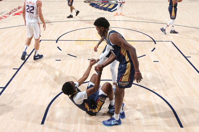 NEW ORLEANS, LA - DECEMBER 5: Herbert Jones #2 of the New Orleans Pelicans gets helped off floor by teammates during the game against the Phoenix Suns on December 5, 2024 at the Smoothie King Center in New Orleans, Louisiana. NOTE TO USER: User expressly acknowledges and agrees that, by downloading and or using this Photograph, user is consenting to the terms and conditions of the Getty Images License Agreement. Mandatory Copyright Notice: Copyright 2024 NBAE (Photo by Layne Murdoch Jr./NBAE via Getty Images)