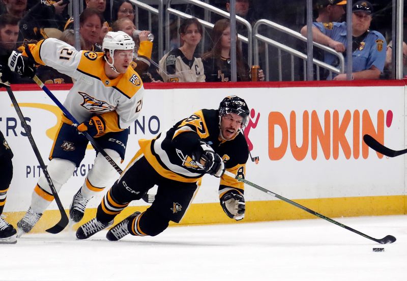 Apr 15, 2024; Pittsburgh, Pennsylvania, USA;  Nashville Predators left wing Anthony Beauvillier (21) commits a tripping penalty on Pittsburgh Penguins center Sidney Crosby (87) during the third period at PPG Paints Arena. The Penguins won 4-2. Mandatory Credit: Charles LeClaire-USA TODAY Sports