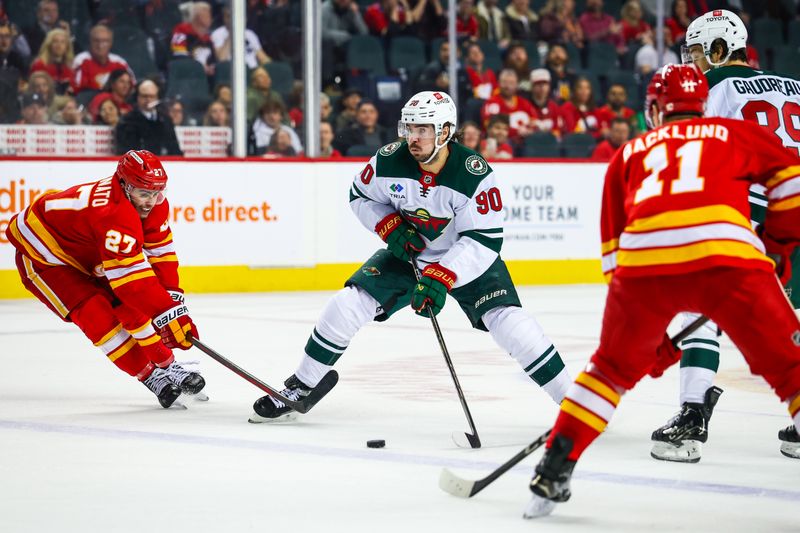 Apr 11, 2025; Calgary, Alberta, CAN; Minnesota Wild left wing Marcus Johansson (90) controls the puck against Calgary Flames right wing Matt Coronato (27) during the third period at Scotiabank Saddledome. Mandatory Credit: Sergei Belski-Imagn Images