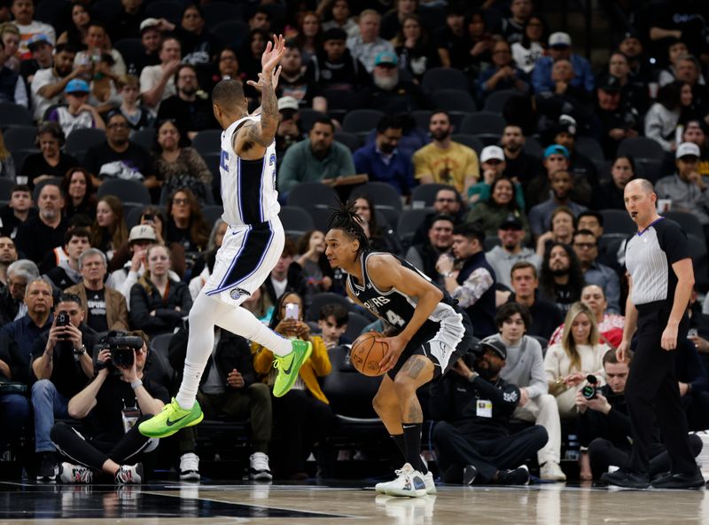 SAN ANTONIO, TX - JANUARY  31:  Devin Vassell #24 of the San Antonio Spurs waits for Markelle Fultz #20 of the Orlando Magic to fly by before shooting in the first half at Frost Bank Center on January 31, 2024 in San Antonio, Texas. NOTE TO USER: User expressly acknowledges and agrees that, by downloading and or using this photograph, User is consenting to terms and conditions of the Getty Images License Agreement. (Photo by Ronald Cortes/Getty Images)