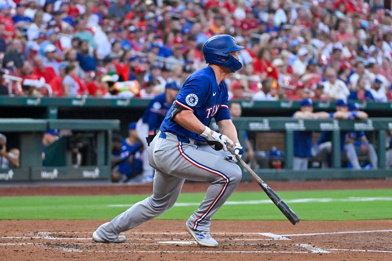 Jul 29, 2024; St. Louis, Missouri, USA;  Texas Rangers shortstop Corey Seager (5) hits a one run double against the St. Louis Cardinals during the third inning at Busch Stadium. Mandatory Credit: Jeff Curry-USA TODAY Sports