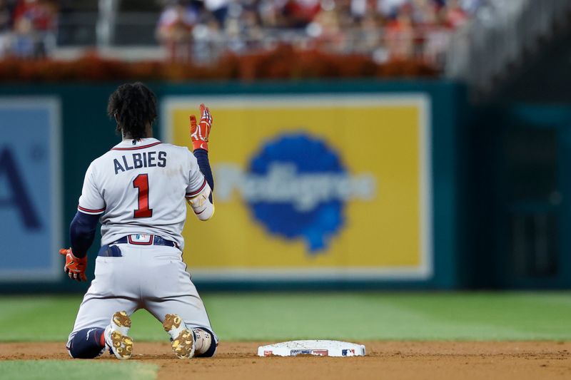 VSep 21, 2023; Washington, District of Columbia, USA; Atlanta Braves second baseman Ozzie Albies (1) reacts at second base after hitting an RBI double against the Washington Nationals during the third inning at Nationals Park. It was Albies' 100th RBI on the season. Mandatory Credit: Geoff Burke-USA TODAY Sports