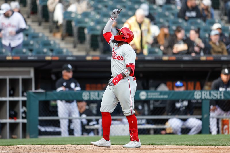 Apr 18, 2023; Chicago, Illinois, USA; Philadelphia Phillies second baseman Josh Harrison (2) celebrates as he crosses home plate  after hitting a two-run home run against the Chicago White Sox during the seventh inning of game one of the doubleheader at Guaranteed Rate Field. Mandatory Credit: Kamil Krzaczynski-USA TODAY Sports