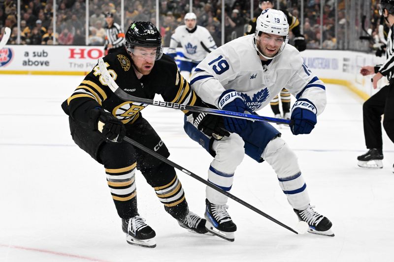 Apr 22, 2024; Boston, Massachusetts, USA; Boston Bruins defenseman Matt Grzelcyk (48) and Toronto Maple Leafs center Calle Jarnkrok (19) battle for the puck during the second period in game two of the first round of the 2024 Stanley Cup Playoffs at TD Garden. Mandatory Credit: Brian Fluharty-USA TODAY Sports