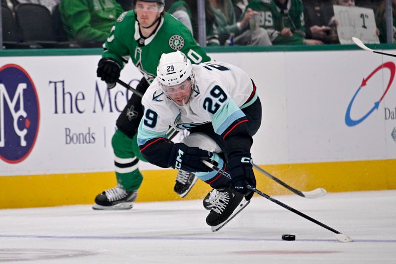 Feb 25, 2026; Dallas, Texas, USA;  Seattle Kraken defenseman Vince Dunn (29) falls to the ice in front of Dallas Stars center Oskar Back (10) during the first period at the American Airlines Center. Mandatory Credit: Jerome Miron-Imagn Images