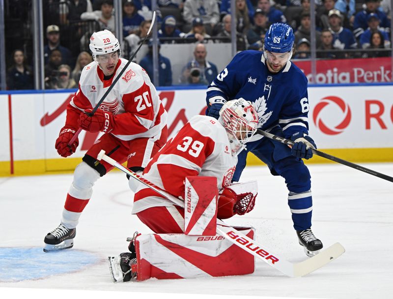 Oct 13, 2025; Toronto, Ontario, CAN; Detroit Red Wings goalie Cameron Talbot (39) makes a save in front of defenceman Albert Johansson (20) and Toronto Maple Leafs left wing Matias Maccelli (63) in the first period at Scotiabank Arena. Mandatory Credit: Gerry Angus-Imagn Images