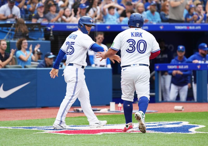 Sep 9, 2023; Toronto, Ontario, CAN; Toronto Blue Jays left fielder Daulton Varsho (25) and catcher Alejandro Kirk (30)  celebrate scoring runs against the Kansas City Royals during the fifth inning at Rogers Centre. Mandatory Credit: Nick Turchiaro-USA TODAY Sports