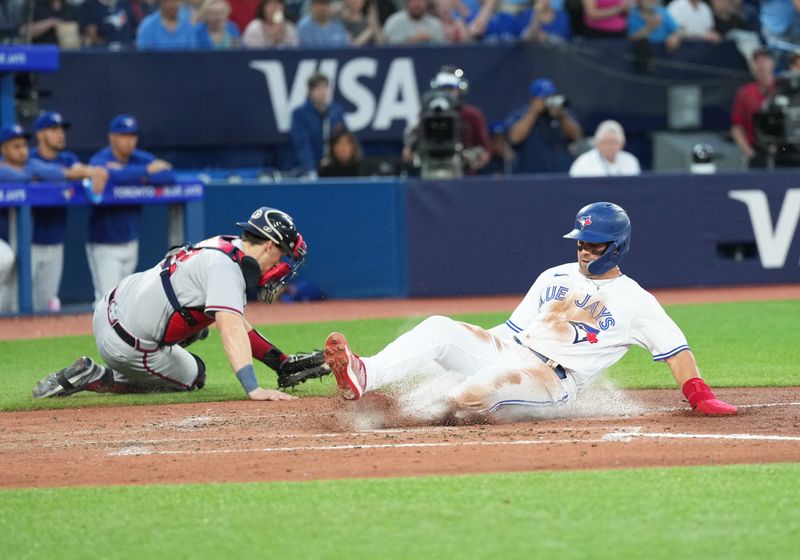 May 12, 2023; Toronto, Ontario, CAN; Toronto Blue Jays second baseman Whit Merrifield (15) slides into home plate scoring a run ahead of the tag from Atlanta Braves catcher Sean Murphy (12) during the fifth inning at Rogers Centre. Mandatory Credit: Nick Turchiaro-USA TODAY Sports