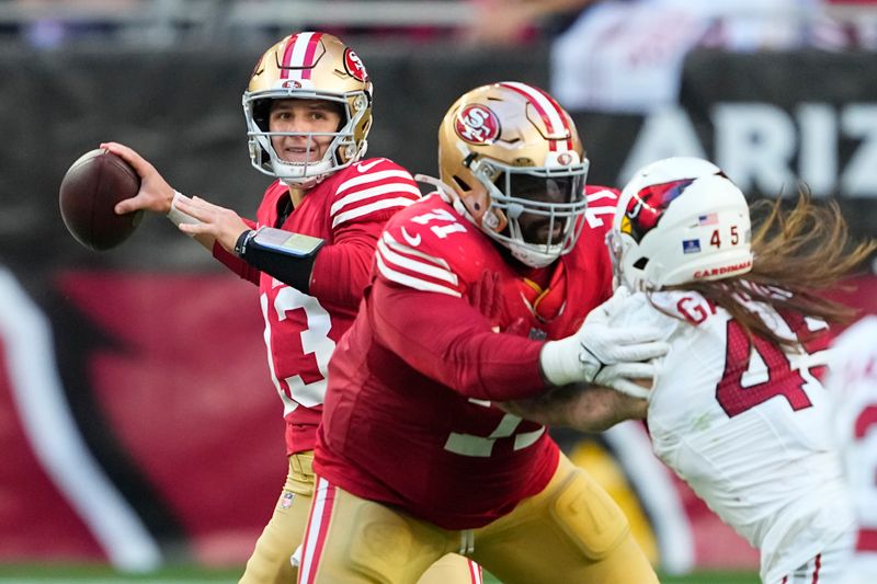 San Francisco 49ers quarterback Brock Purdy (13) passes as offensive tackle Trent Williams blocks Arizona Cardinals linebacker Dennis Gardeck (45) during the second half of an NFL football game Sunday, Dec. 17, 2023, in Glendale, Ariz. (AP Photo/Matt York)