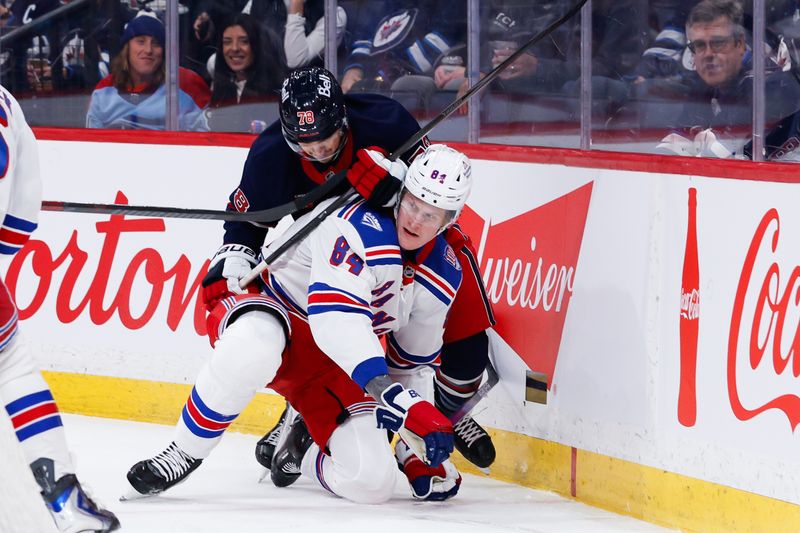 Mar 12, 2026; Winnipeg, Manitoba, CAN;  Winnipeg Jets defenseman Jacob Bryson (78) checks New York Rangers forward Adam Edstrom (84) during the first period at Canada Life Centre. Mandatory Credit: Terrence Lee-Imagn Images
