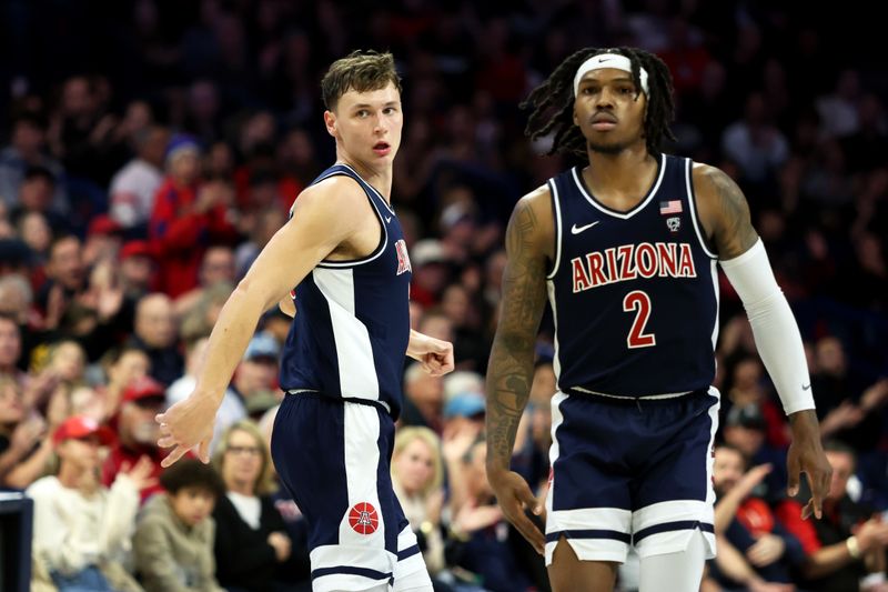 Jan 17, 2024; Tucson, Arizona, USA; Arizona Wildcats guard Pelle Larsson (3) runs down the court with guard Caleb Love (2) against the USC Trojans during the second half at McKale Center. Mandatory Credit: Zachary BonDurant-USA TODAY Sports