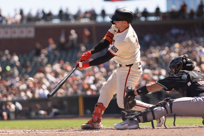 Sep 5, 2024; San Francisco, California, USA;  San Francisco Giants catcher Patrick Bailey (14) hits a two RBI single during the fourth inning against the Arizona Diamondbacks at Oracle Park. Mandatory Credit: Stan Szeto-Imagn Images