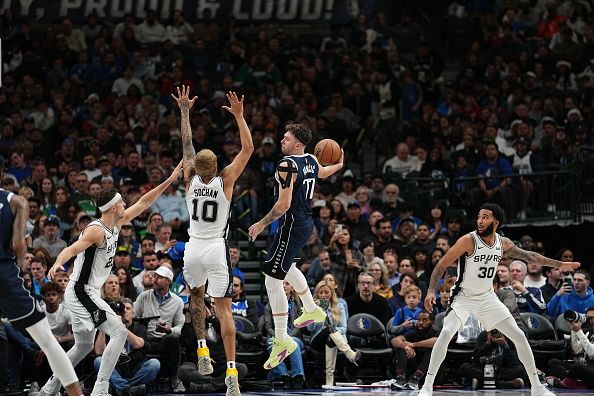 DALLAS, TX - DECEMBER 23: Luka Doncic #77 of the Dallas Mavericks passes the ball during the game against the San Antonio Spurs on December 23, 2023 at the American Airlines Center in Dallas, Texas. NOTE TO USER: User expressly acknowledges and agrees that, by downloading and or using this photograph, User is consenting to the terms and conditions of the Getty Images License Agreement. Mandatory Copyright Notice: Copyright 2023 NBAE (Photo by Glenn James/NBAE via Getty Images)