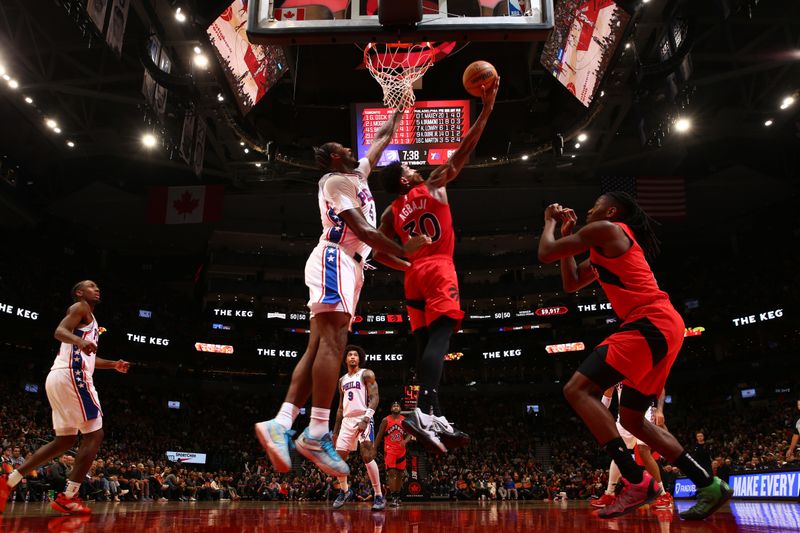 TORONTO, CANADA - OCTOBER 25: Ochai Agbaji #30 of the Toronto Raptors drives to the basket during the game against the Philadelphia 76ers on October 25, 2024 at the Scotiabank Arena in Toronto, Ontario, Canada.  NOTE TO USER: User expressly acknowledges and agrees that, by downloading and or using this Photograph, user is consenting to the terms and conditions of the Getty Images License Agreement.  Mandatory Copyright Notice: Copyright 2024 NBAE (Photo by Vaughn Ridley/NBAE via Getty Images)