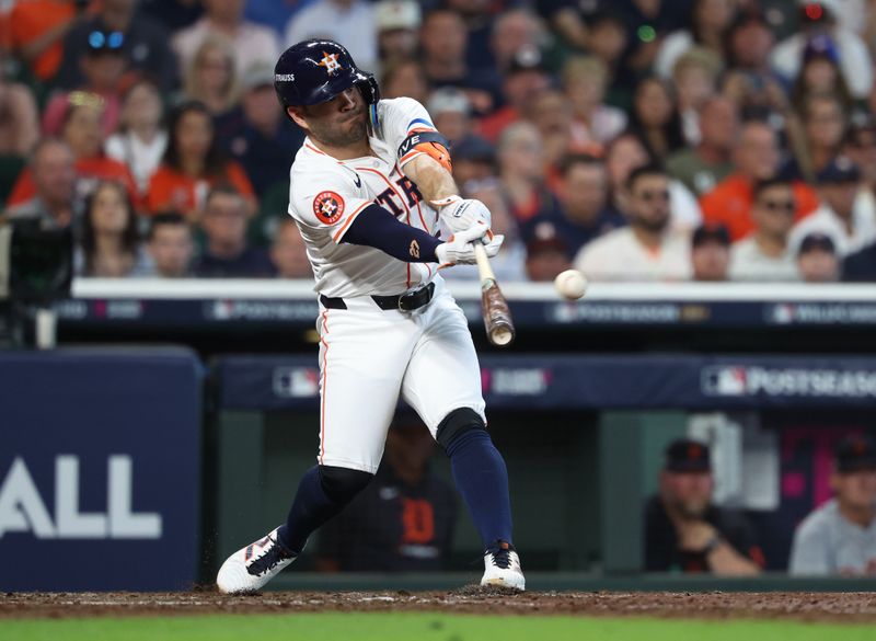 Oct 1, 2024; Houston, Texas, USA; Houston Astros second base Jose Altuve (27) hits a single in the third inning against the Detroit Tigers in game one of the Wild Card round for the 2024 MLB Playoffs at Minute Maid Park. Mandatory Credit: Troy Taormina-Imagn Images