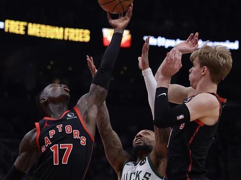 TORONTO, ON- NOVEMBER 15  - Toronto Raptors guard Dennis Schroder (17) hauls in a rebound as Milwaukee Bucks guard Damian Lillard (0) and Toronto Raptors guard Gradey Dick (1) watch as the Toronto Raptors fall to the Milwaukee Bucks 128-112 at Scotiabank Arena in Toronto. November 15, 2023.        (Steve Russell/Toronto Star via Getty Images)