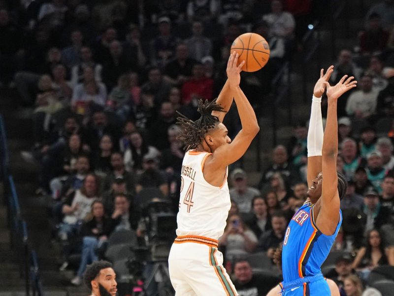 SAN ANTONIO, TX - JANUARY 24: Devin Vassell #24 of the San Antonio Spurs passes the ball during the game against the Oklahoma City Thunder on January 24, 2023 at the Frost Bank Center in San Antonio, Texas. NOTE TO USER: User expressly acknowledges and agrees that, by downloading and or using this photograph, user is consenting to the terms and conditions of the Getty Images License Agreement. Mandatory Copyright Notice: Copyright 2024 NBAE (Photos by Jesse D. Garrabrant/NBAE via Getty Images)