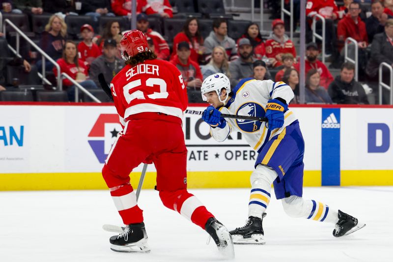 Mar 16, 2024; Detroit, Michigan, USA;  Buffalo Sabres center Dylan Cozens (24) takes a shot defended by Detroit Red Wings defenseman Moritz Seider (53) in the first period at Little Caesars Arena. Mandatory Credit: Rick Osentoski-USA TODAY Sports