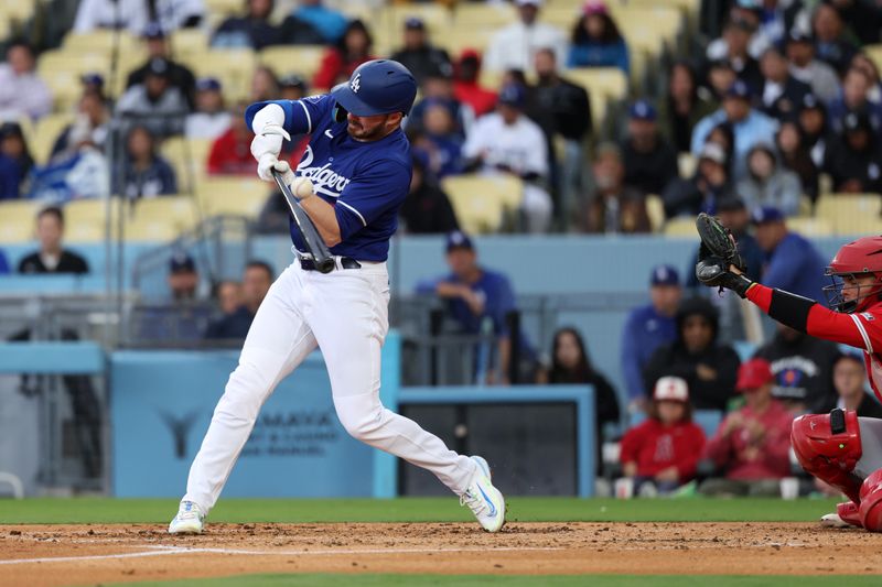 Mar 24, 2024; Los Angeles, California, USA;  Los Angeles Dodgers shortstop Gavin Lux (9) hits an RBI single during the second inning against the Los Angeles Angels at Dodger Stadium. Mandatory Credit: Kiyoshi Mio-USA TODAY Sports