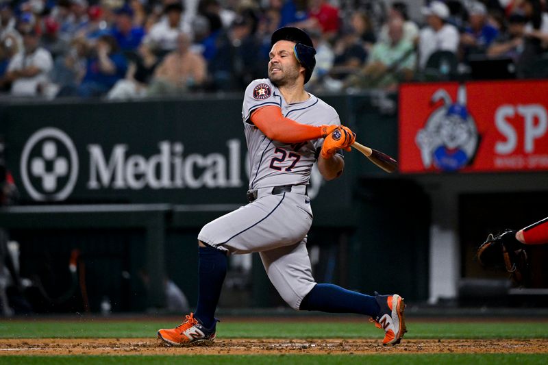 Aug 5, 2024; Arlington, Texas, USA; Houston Astros second baseman Jose Altuve (27) misses the ball while batting against the Texas Rangers during the sixth inning at Globe Life Field. Mandatory Credit: Jerome Miron-USA TODAY Sports