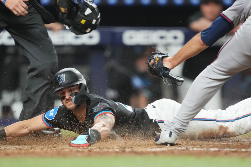 Sep 20, 2024; Miami, Florida, USA;  Miami Marlins third baseman Connor Norby (24) scores on a wild pitch by Atlanta Braves pitcher Charlie Morton (50) in the fifth inning at loanDepot Park. Mandatory Credit: Jim Rassol-Imagn Images