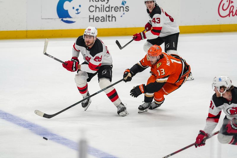 Nov 2, 2025; Anaheim, California, USA; New Jersey Devils right wing Timo Meier (28) of the New Jersey Devils and Anaheim Ducks  center Nikita Nesterenko (13) chase the puck during the third period at Honda Center. Mandatory Credit: Corinne Votaw-Imagn Images