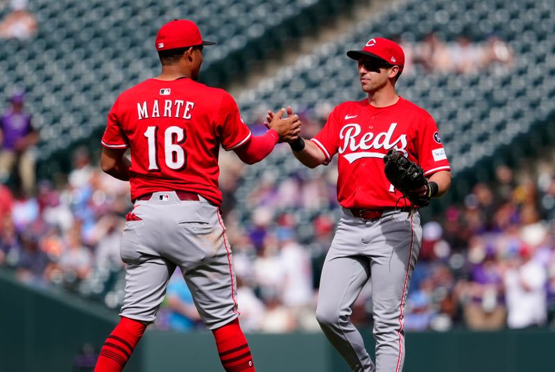 Apr 27, 2025; Denver, Colorado, USA; Cincinnati Reds first baseman Spencer Steer (7) and third baseman Noelvi Marte (16) celebrate defeating the Colorado Rockies at Coors Field. Mandatory Credit: Ron Chenoy-Imagn Images