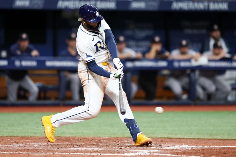 Aug 13, 2024; St. Petersburg, Florida, USA; Tampa Bay Rays third baseman Junior Caminero (13) singles against the Houston Astros in the fourth inning at Tropicana Field. Mandatory Credit: Nathan Ray Seebeck-USA TODAY Sports