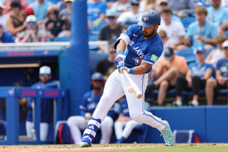 Mar 20, 2025; Dunedin, Florida, USA; Toronto Blue Jays outfielder Anthony Santander (25) hits a two rbi double against the Tampa Bay Rays in the fifth inning during spring training at TD Ballpark. Mandatory Credit: Nathan Ray Seebeck-Imagn Images