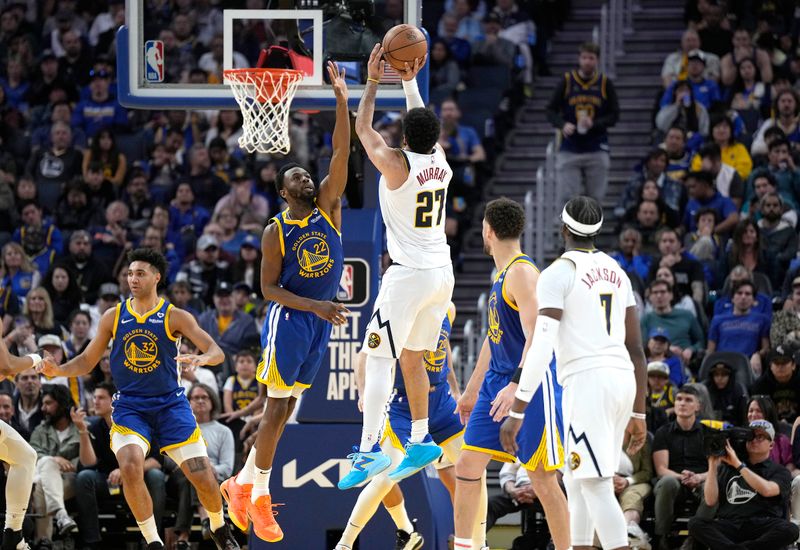 SAN FRANCISCO, CALIFORNIA - FEBRUARY 25: Jamal Murray #27 of the Denver Nuggets shoots over Andrew Wiggins #22 of the Golden State Warriors during the fourth quarter of an NBA basketball game at Chase Center on February 25, 2024 in San Francisco, California. NOTE TO USER: User expressly acknowledges and agrees that, by downloading and or using this photograph, User is consenting to the terms and conditions of the Getty Images License Agreement. (Photo by Thearon W. Henderson/Getty Images)