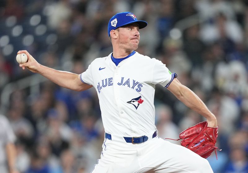 Apr 15, 2024; Toronto, Ontario, CAN; Toronto Blue Jays pitcher Chris Bassitt wearing number 42 for Jackie Robinson Day throws a pitch against the New York Yankees during the first inning at Rogers Centre. Mandatory Credit: Nick Turchiaro-USA TODAY Sports