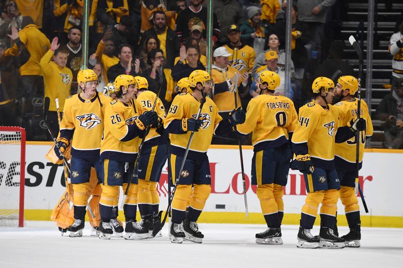 Jan 2, 2024; Nashville, Tennessee, USA; Nashville Predators players celebrate after a win against the Chicago Blackhawks  at Bridgestone Arena. Mandatory Credit: Christopher Hanewinckel-USA TODAY Sports