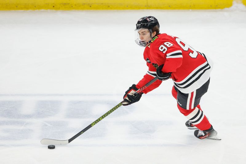 Feb 25, 2024; Chicago, Illinois, USA; Chicago Blackhawks center Connor Bedard (98) controls the puck against the Detroit Red Wings during the first period at United Center. Mandatory Credit: Kamil Krzaczynski-USA TODAY Sports