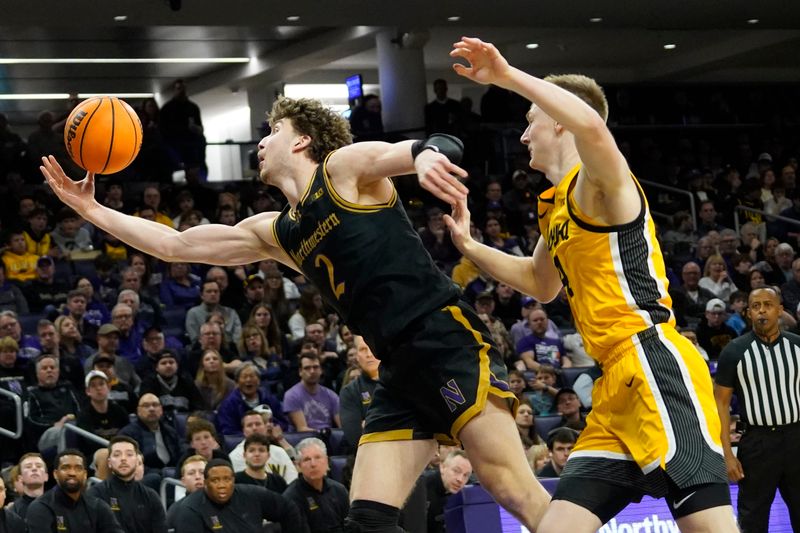 Feb 28, 2025; Evanston, Illinois, USA; Iowa Hawkeyes guard Josh Dix (4) defends Northwestern Wildcats forward Nick Martinelli (2) during the second half at Welsh-Ryan Arena. Mandatory Credit: David Banks-Imagn Images